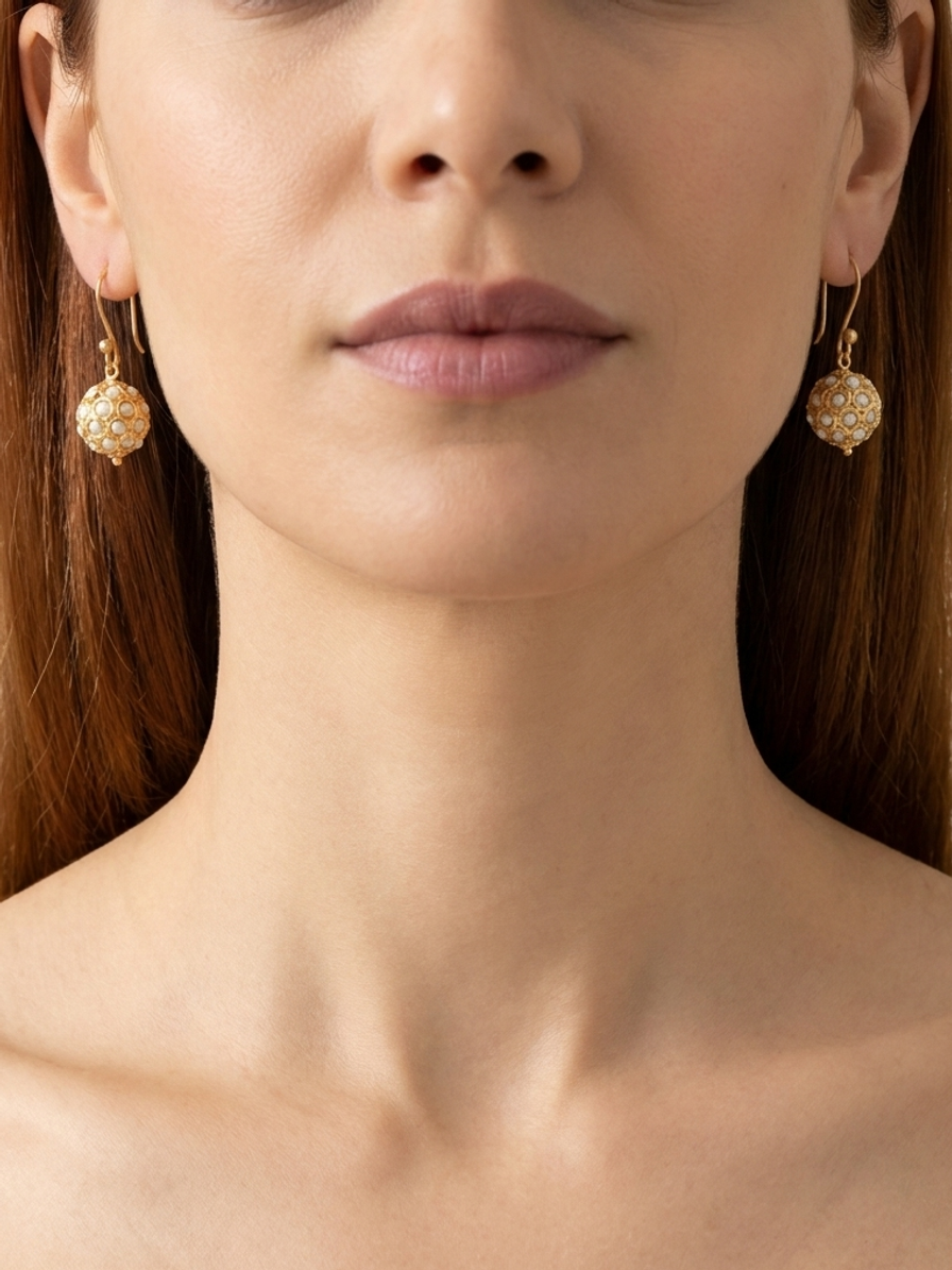 Ivory Pavilion Drops — handmade white pearl-toned beads jewelry by Sima & Sid, shown on a model
