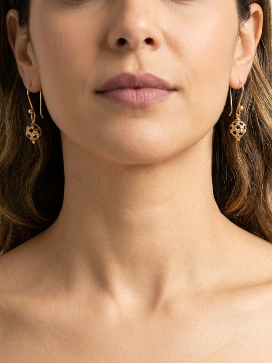 Noir Honeycomb Drops — handmade gold-tone metal jewelry by Sima & Sid, shown on a model