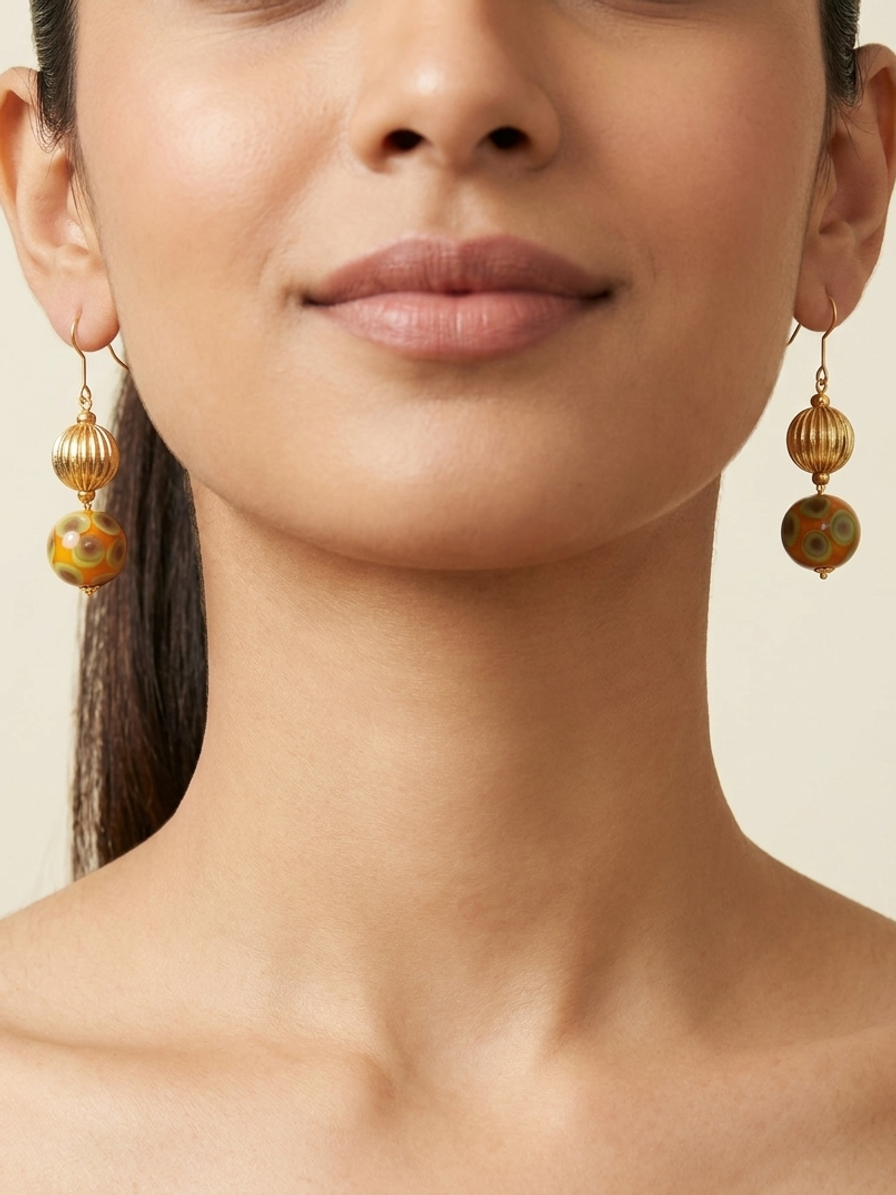 Ochre Majlis Drops — handmade patterned glass beads jewelry by Sima & Sid, shown on a model