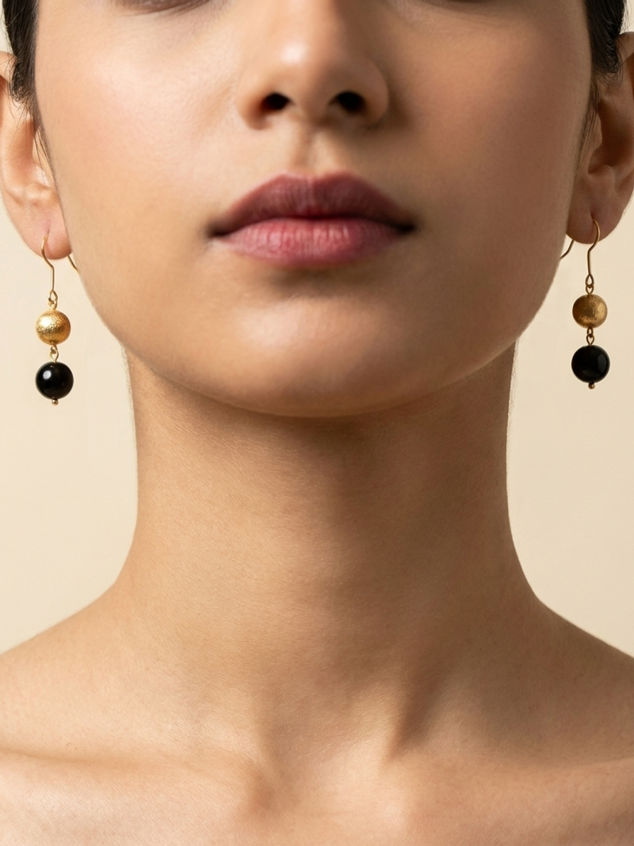 Gilded Noir Drops — handmade gold-tone metal beads jewelry by Sima & Sid, shown on a model