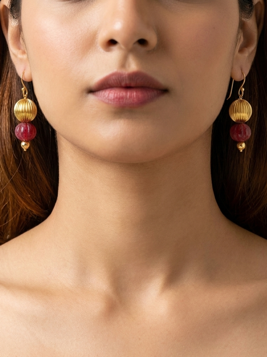 Raspberry Pavilion Drops — handmade gold-tone metal beads jewelry by Sima & Sid, shown on a model